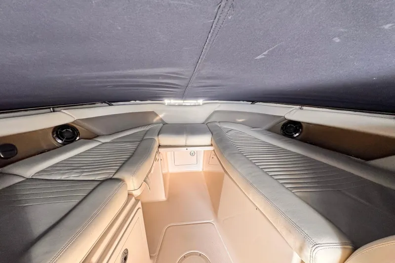 Slide: The Image of Interior cabin of 2014 Grady-White Freedom 335 boat, featuring cushioned seating and storage. - 31