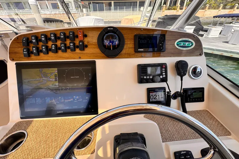 Slide: The Image of Helm of 2014 Grady-White Freedom 335 boat with navigation and control systems. - 33