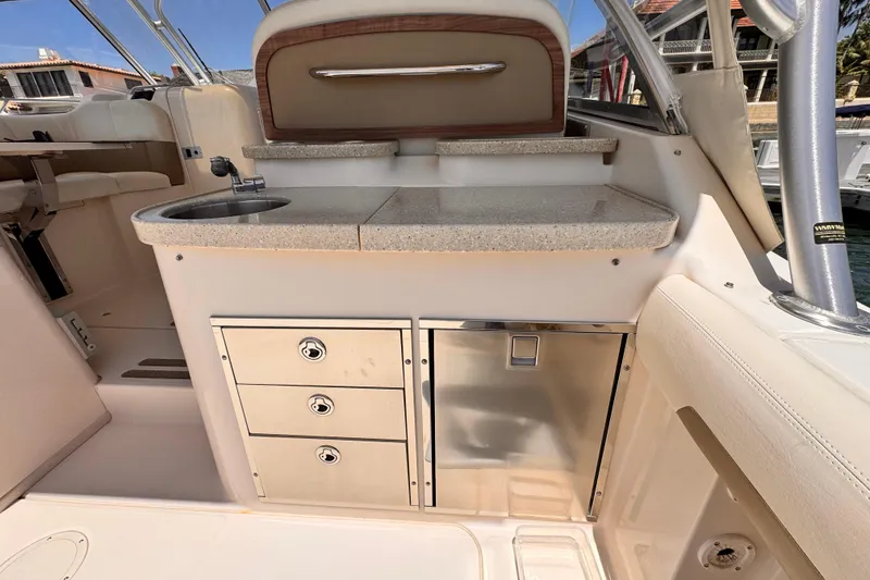 Slide: The Image of 2014 Grady-White Freedom 335 boat interior with sink, storage drawers, and countertop. - 36