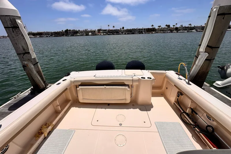 Slide: The Image of 2014 Grady-White Freedom 335 boat docked, showcasing spacious deck and serene waterfront view. - 40