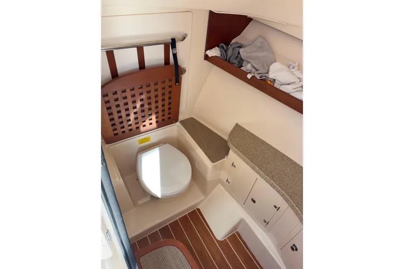 Slide: The Image of 2014 Grady-White Freedom 335 boat interior with toilet and storage area. - 41