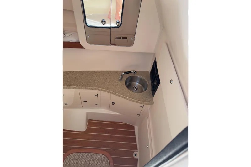 Slide: The Image of 2014 Grady-White Freedom 335 boat interior with sink and wooden flooring. - 42