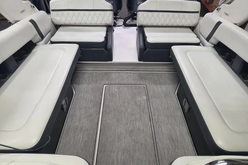 Slide: The Image of 2019 Regal 29 OBX boat interior with white cushioned seating and gray flooring. - 11