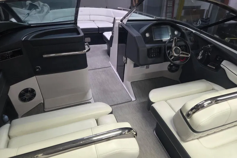 Slide: The Image of 2019 Regal 29 OBX boat interior with modern helm, plush seating, and sleek design. - 12