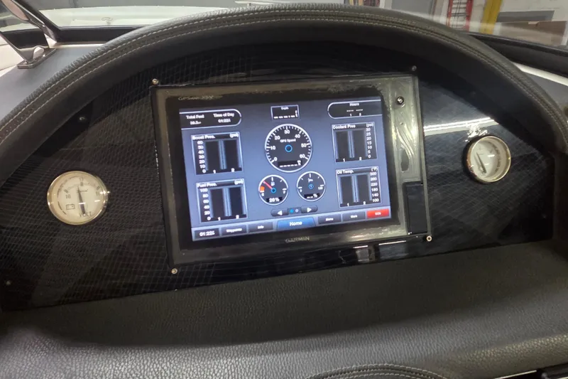Slide: The Image of Dashboard of a 2019 Regal 29 OBX boat featuring a Garmin display and gauges. - 13