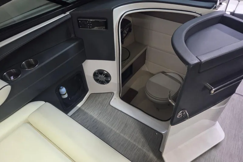 Slide: The Image of 2019 Regal 29 OBX boat interior with compact bathroom and seating area. - 15