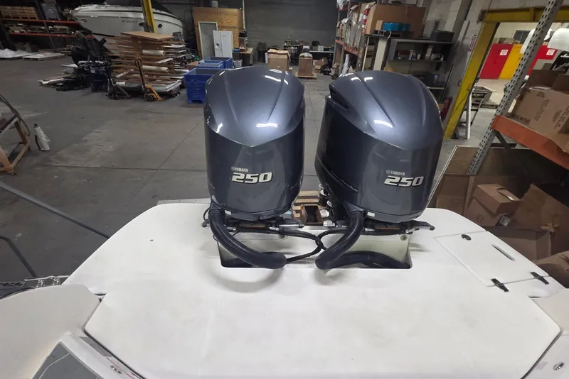 Slide: The Image of 2019 Regal 29 OBX boat with dual Yamaha 250 outboard engines in a workshop setting. - 2