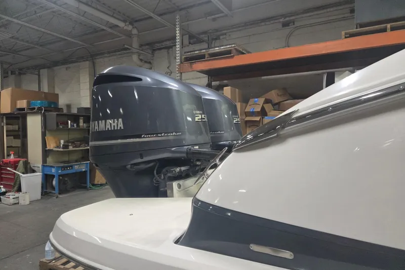 Slide: The Image of 2019 Regal 29 OBX with Yamaha outboard engines in a workshop setting. - 20