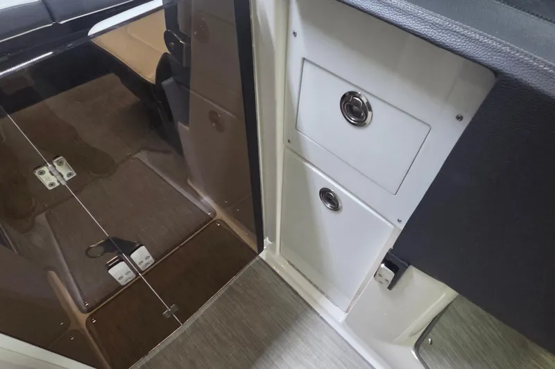 Slide: The Image of 2019 Regal 29 OBX interior showing storage compartments and sleek flooring design. - 21