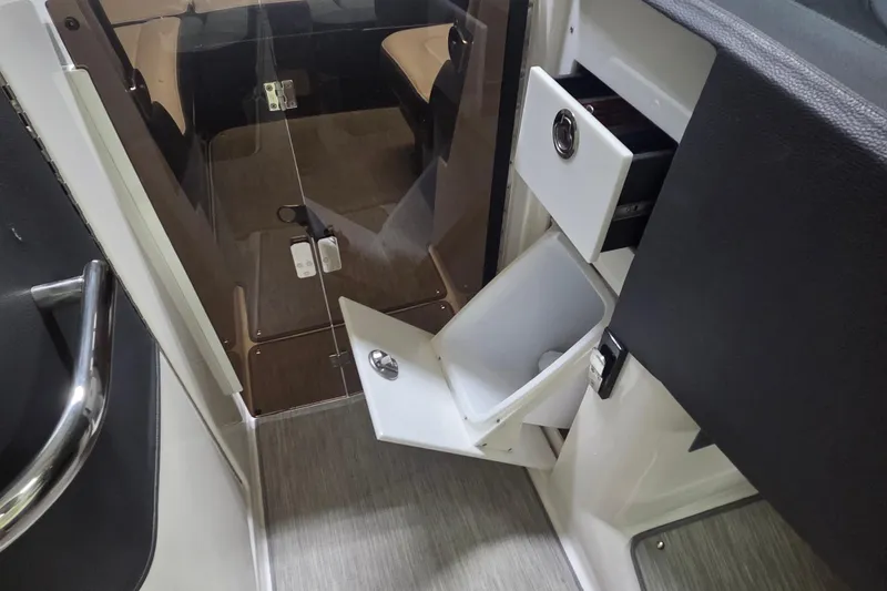 Slide: The Image of 2019 Regal 29 OBX interior with open storage compartments and modern design. - 22
