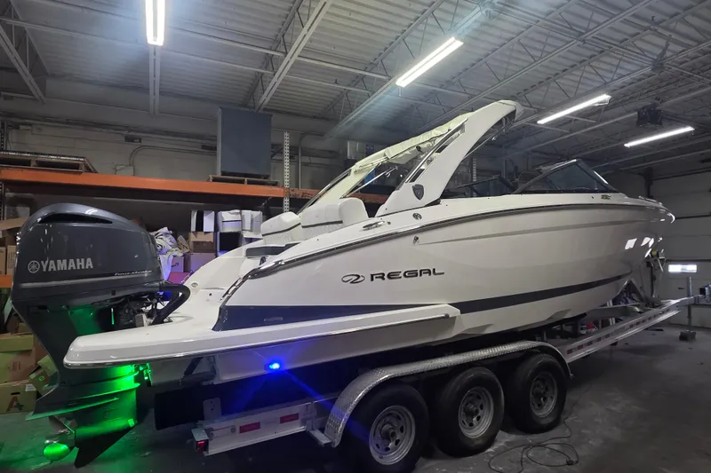 Slide: The Image of 2019 Regal 29 OBX boat with Yamaha engine on a trailer in a warehouse. - 24
