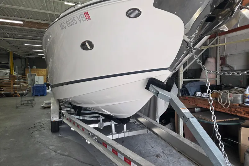 Slide: The Image of 2019 Regal 29 OBX boat on trailer in a warehouse setting. - 27