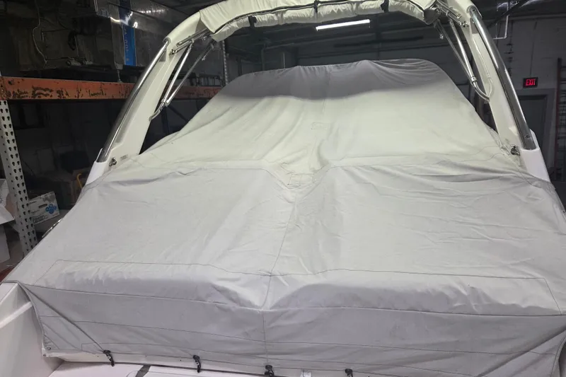 Slide: The Image of 2019 Regal 29 OBX boat covered with a protective tarp in storage. - 28