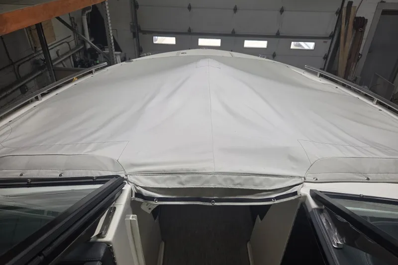Slide: The Image of 2019 Regal 29 OBX boat with protective cover in a garage setting. - 29