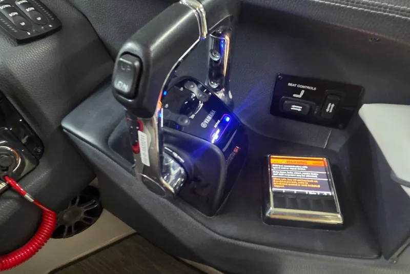 Slide: The Image of 2019 Regal 29 OBX boat controls with throttle lever and seat adjustment panel. - 4