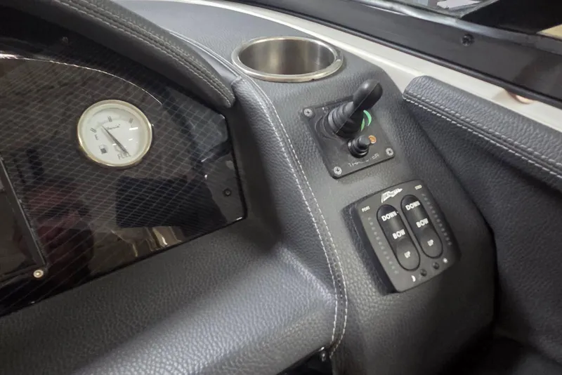 Slide: The Image of Dashboard controls of a 2019 Regal 29 OBX boat, featuring a gauge and switches. - 5
