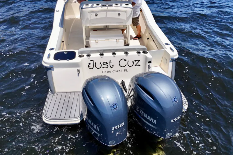 Slide: The Image of 2023 Scout 255 LXF boat with twin Yamaha engines on water, named "Just Cuz." - 10