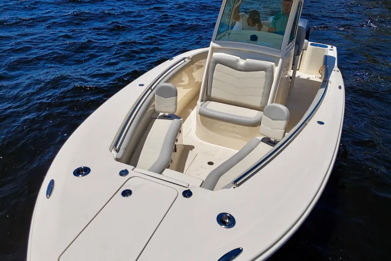Slide: The Image of 2023 Scout 255 LXF boat on water, featuring sleek design and comfortable seating. - 11