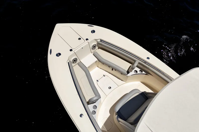 Slide: The Image of 2023 Scout 255 LXF boat interior with seating and speakers, on dark water background. - 12