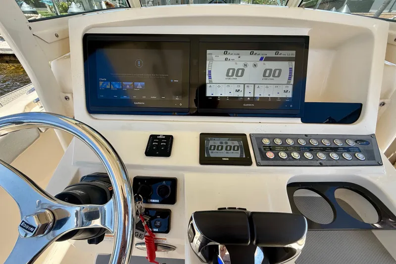 Slide: The Image of 2023 Scout 255 LXF boat dashboard with Garmin displays and Yamaha controls. - 20