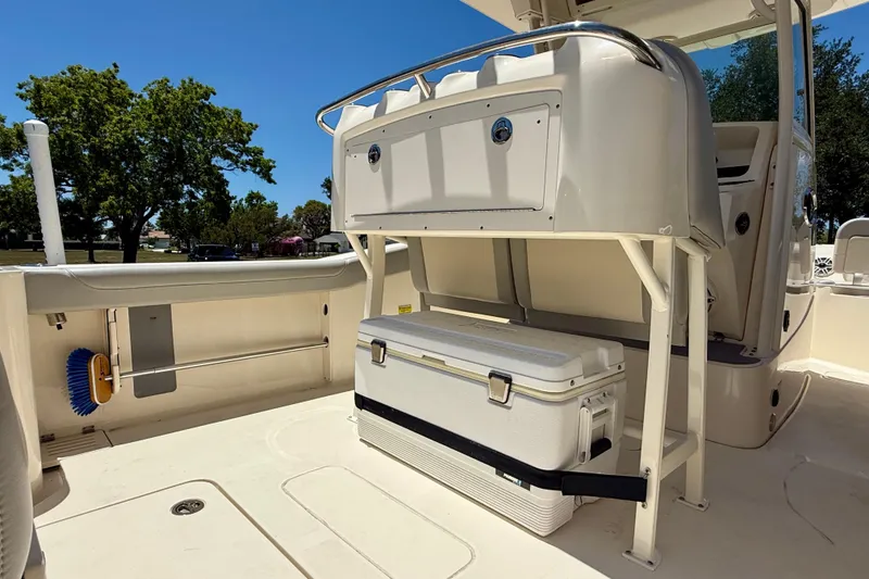 Slide: The Image of 2023 Scout 255 LXF boat interior with storage and cooler, featuring sleek design elements. - 23