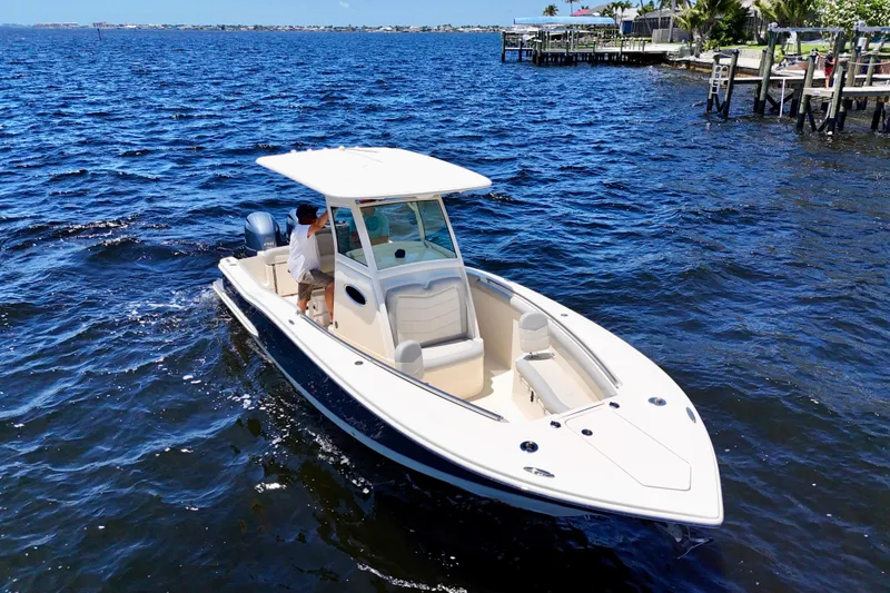 Slide: The Image of 2023 Scout 255 LXF boat cruising on a sunny day in open water. - 4