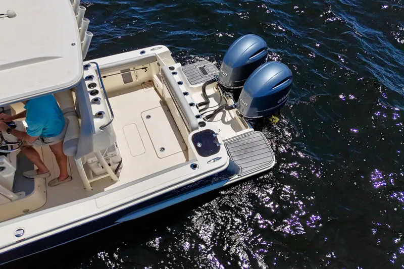 Slide: The Image of 2023 Scout 255 LXF boat with dual outboard engines on water. - 9
