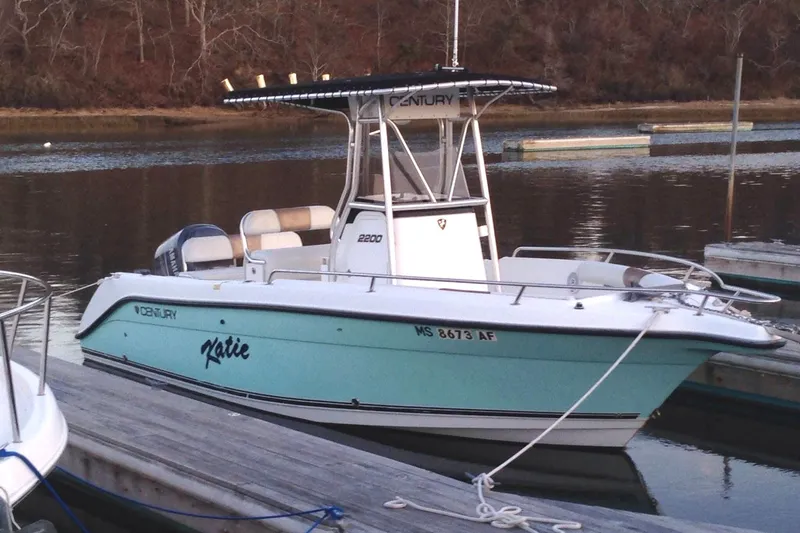 Slide: The Image of 2004 Century 2200 Center Console boat docked on calm water. - 7