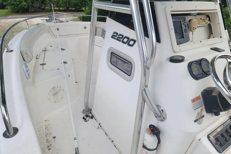 Slide: The Image of 2004 Century 2200 Center Console boat interior with steering wheel and control panel. - 8