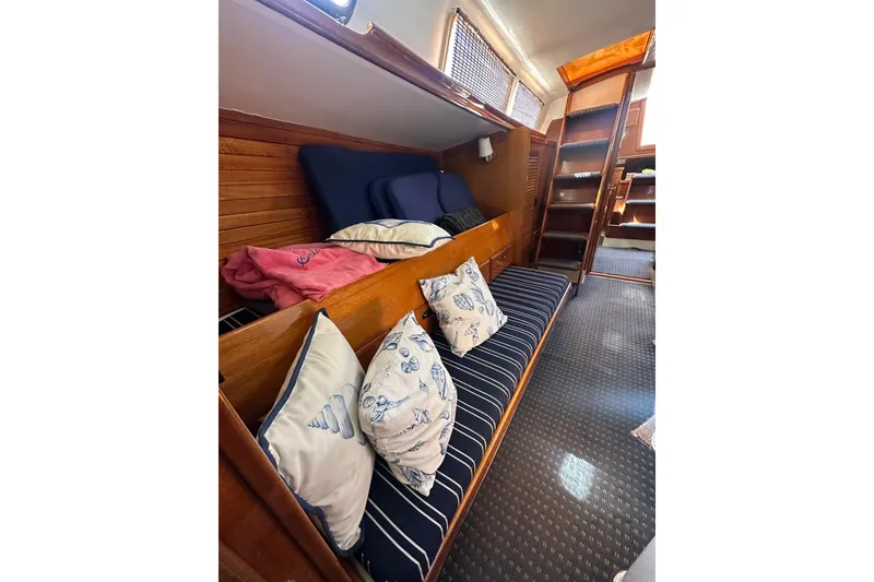 Slide: The Image of Interior of 1966 CAL Cal 48 sailboat with cozy seating and nautical-themed cushions. - 23