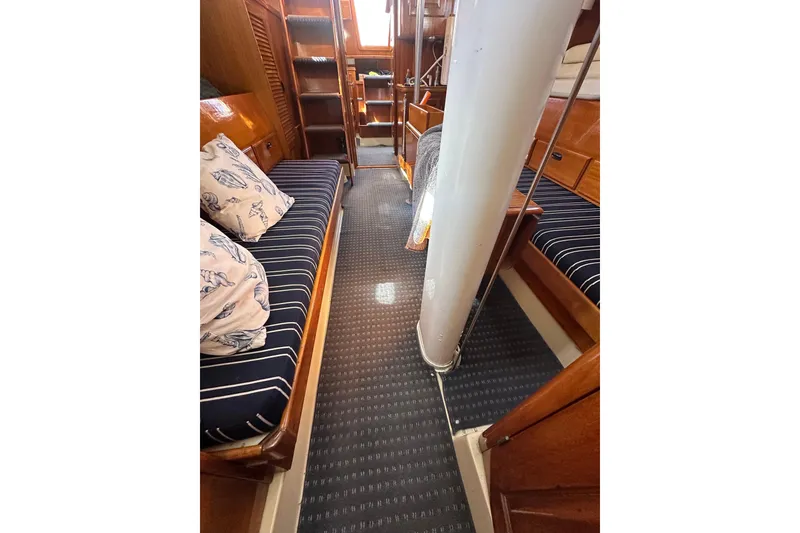 Slide: The Image of Interior of 1966 CAL Cal 48 sailboat with striped seating and wooden finishes. - 25