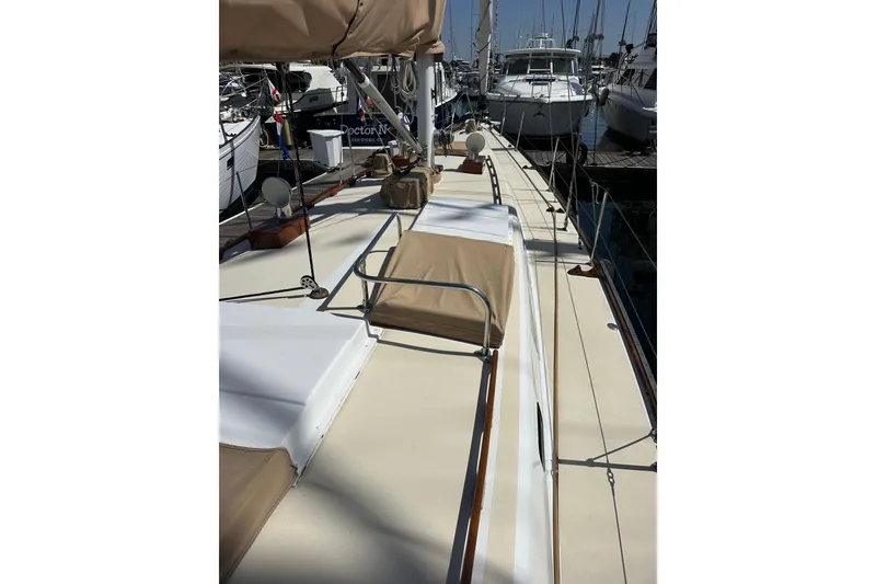 Slide: The Image of 1966 CAL Cal 48 sailboat deck view, docked in a marina with other boats. - 26