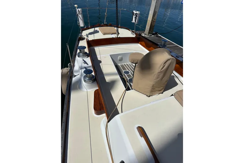 Slide: The Image of 1966 CAL Cal 48 sailboat deck with winches and covered helm, docked at marina. - 27