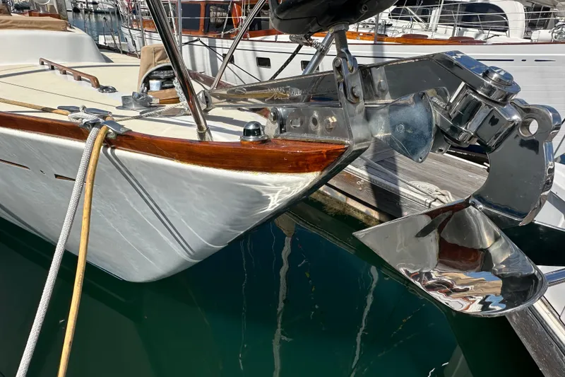 Slide: The Image of Bow of a 1966 CAL Cal 48 yacht with polished anchor and wooden trim. - 28