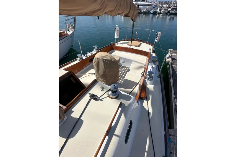 Slide: The Image of 1966 CAL Cal 48 sailboat docked at marina, showcasing deck and winches. - 3