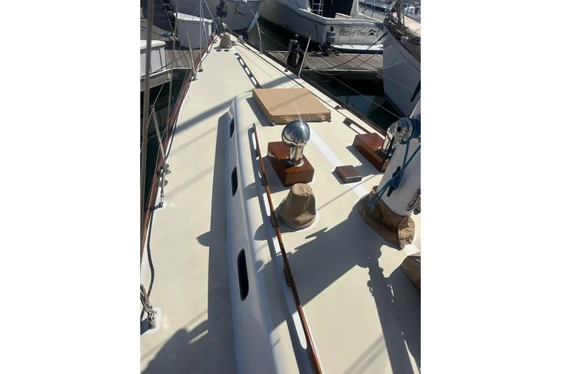 Slide: The Image of Deck view of a 1966 CAL Cal 48 sailboat, showcasing clean lines and nautical equipment. - 4