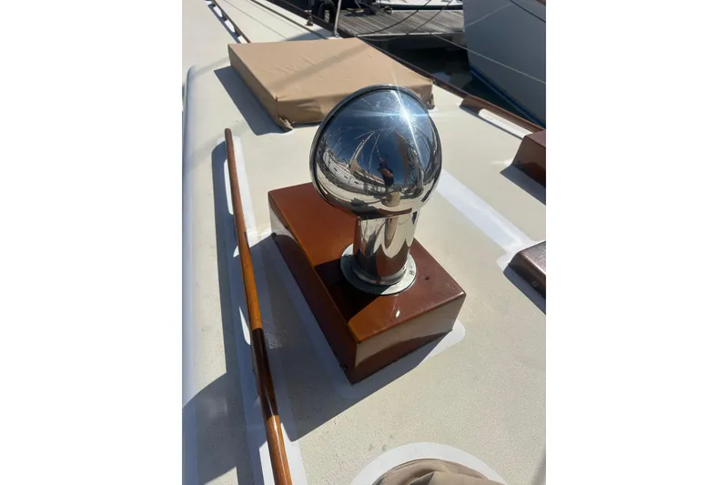 Slide: The Image of Polished chrome fitting on 1966 CAL Cal 48 yacht deck, reflecting surroundings. - 5
