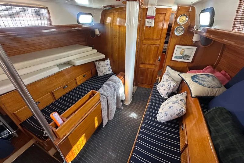 Slide: The Image of Interior of a 1966 CAL Cal 48 sailboat with cozy seating and nautical decor. - 8