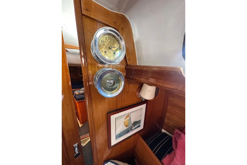 Slide: The Image of Interior of 1966 CAL Cal 48 yacht with clock, barometer, and nautical artwork. - 9
