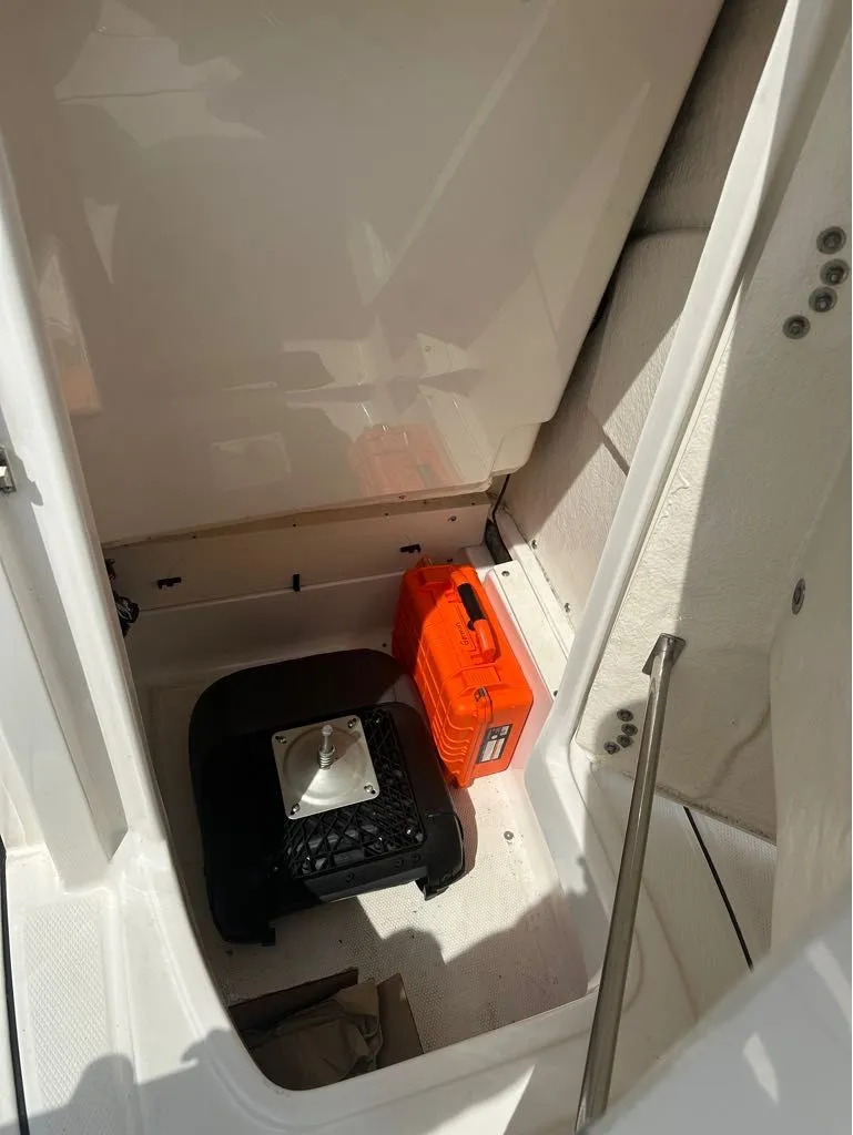 Slide: The Image of Interior of 2023 Robalo 226 Caymen boat with storage area. - 11