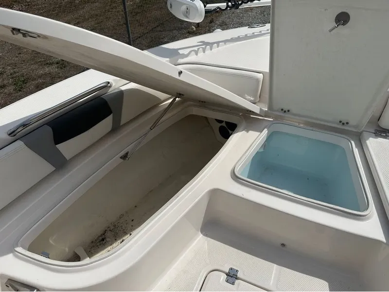Slide: The Image of 2023 Robalo 226 Caymen boat with open storage and seating area. - 17
