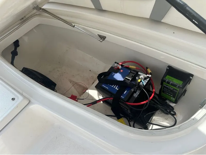 Slide: The Image of Battery compartment of 2023 Robalo 226 Caymen boat with charger. - 6