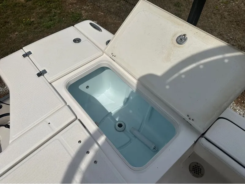 Slide: The Image of Robalo 226 Caymen 2023 boat with open storage compartment lid. - 7