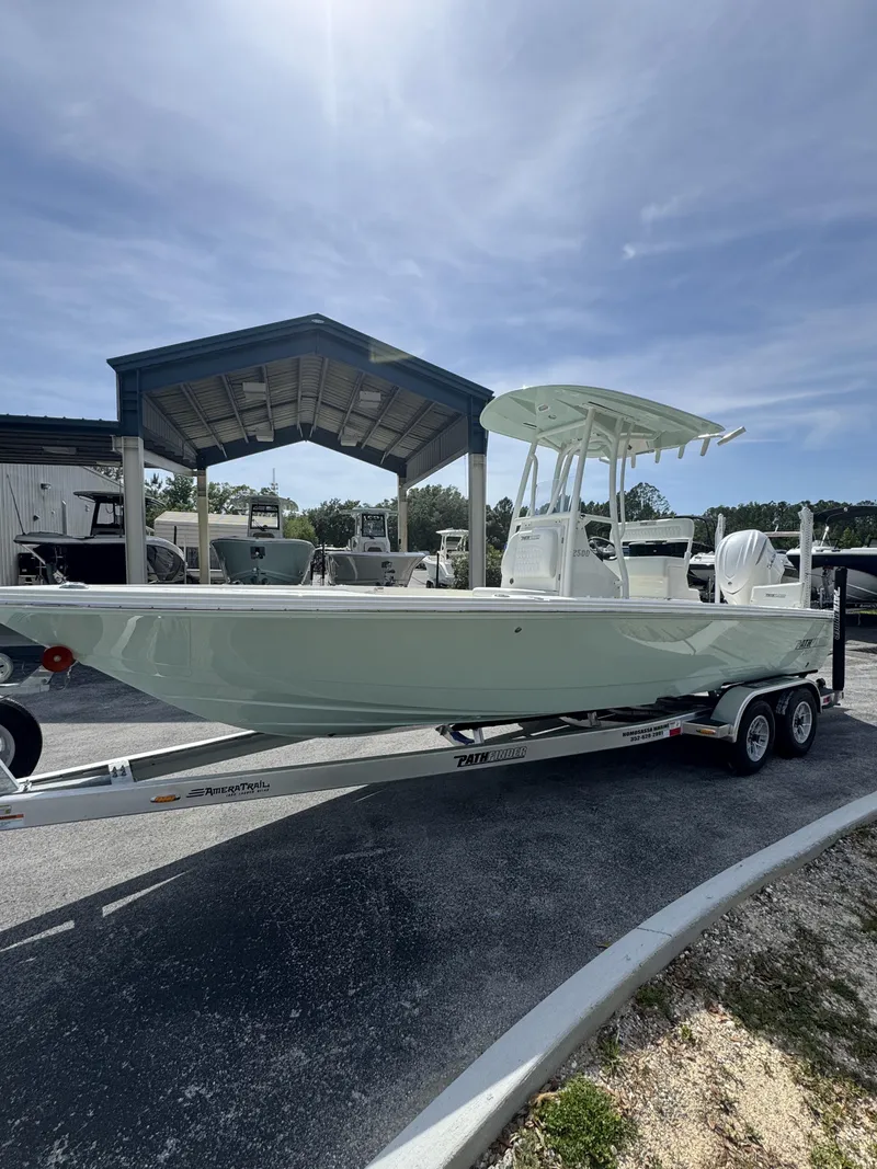 Slide: The Image of 2026 Pathfinder 2500 Hybrid boat on trailer under blue sky. - 13