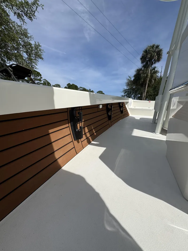 Slide: The Image of Pathfinder 2500 Hybrid 2026 boat deck with wood paneling. - 20