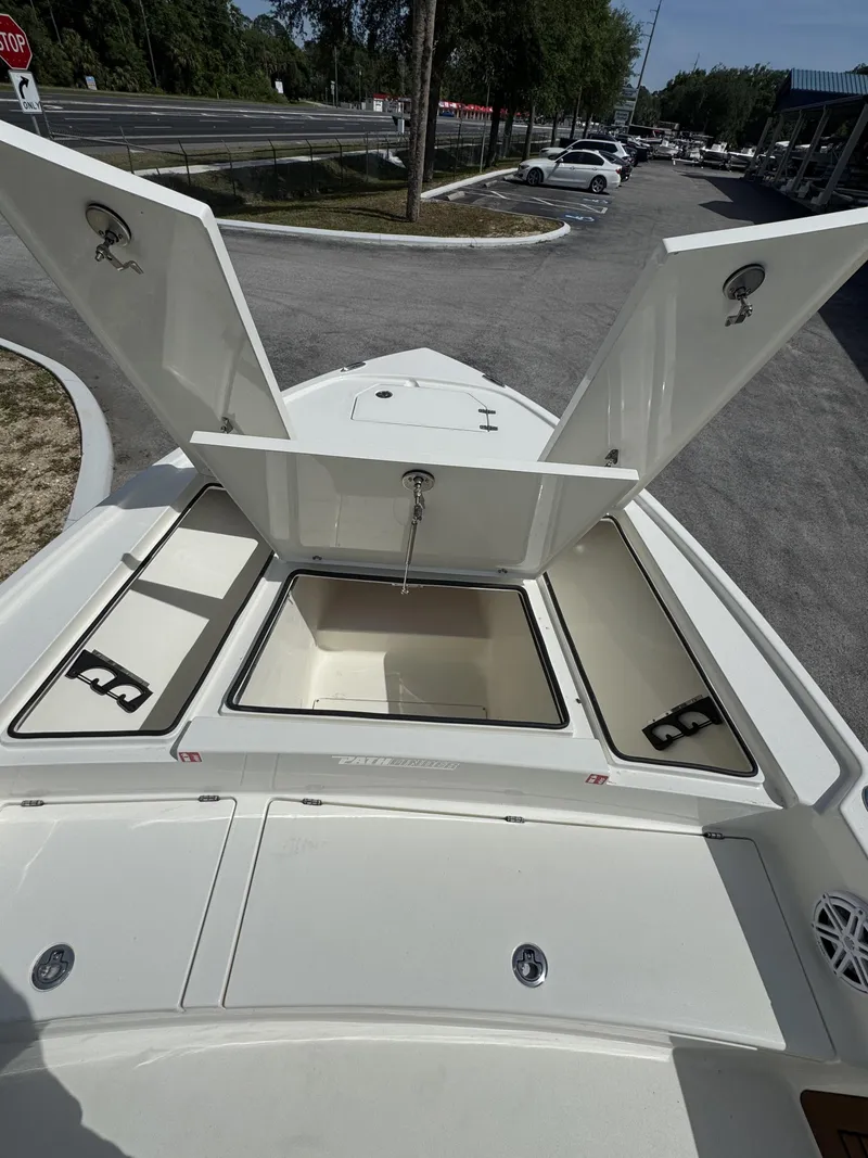Slide: The Image of 2026 Pathfinder 2500 Hybrid boat with open storage compartments on deck. - 21