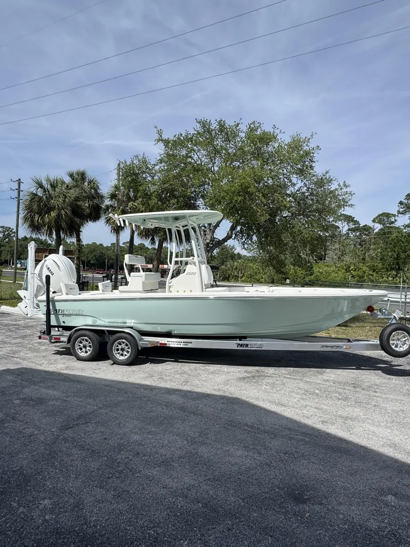 Slide: The Image of 2026 Pathfinder 2500 Hybrid boat parked on trailer outdoors. - 3