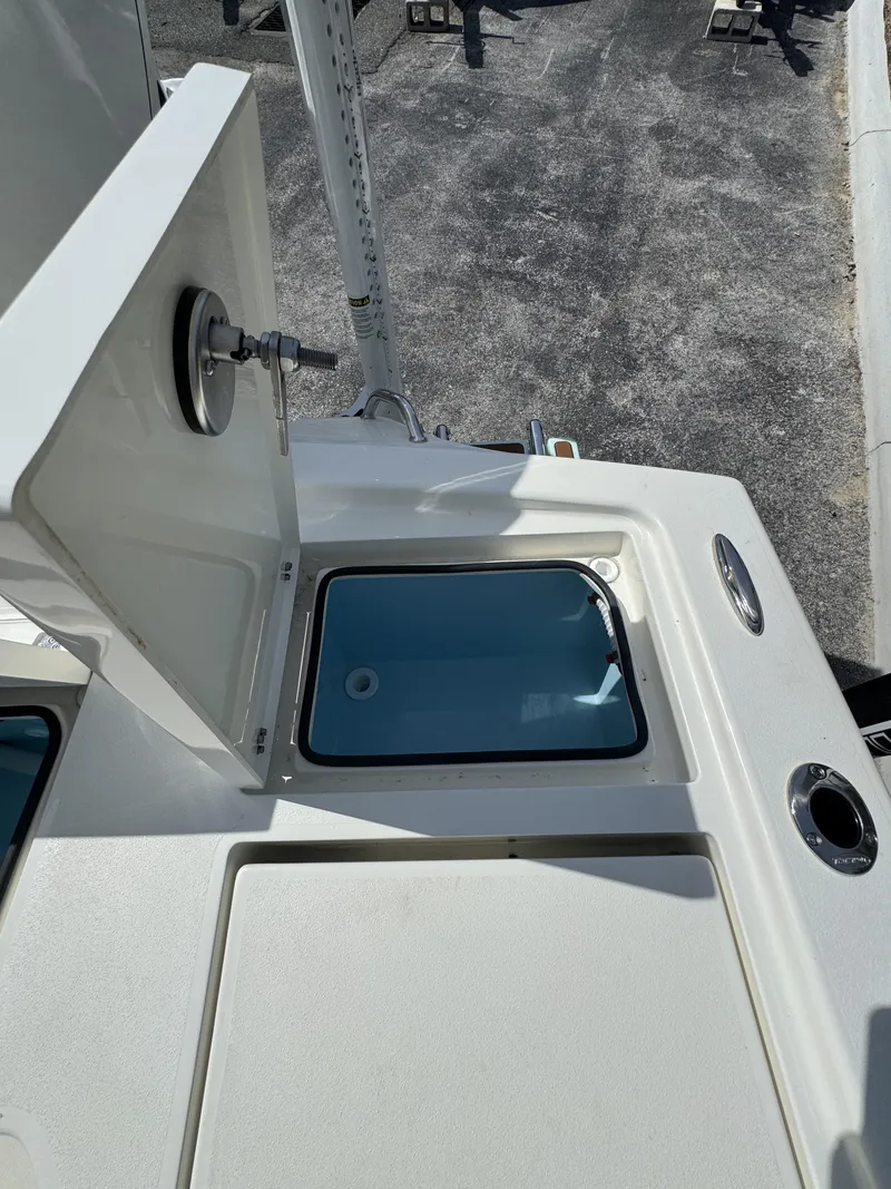 Slide: The Image of Pathfinder 2500 Hybrid 2026 boat with open storage compartment. - 34