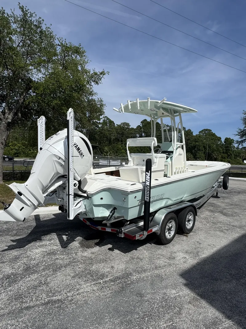 Slide: The Image of 2026 Pathfinder 2500 Hybrid boat parked on trailer outdoors. - 4