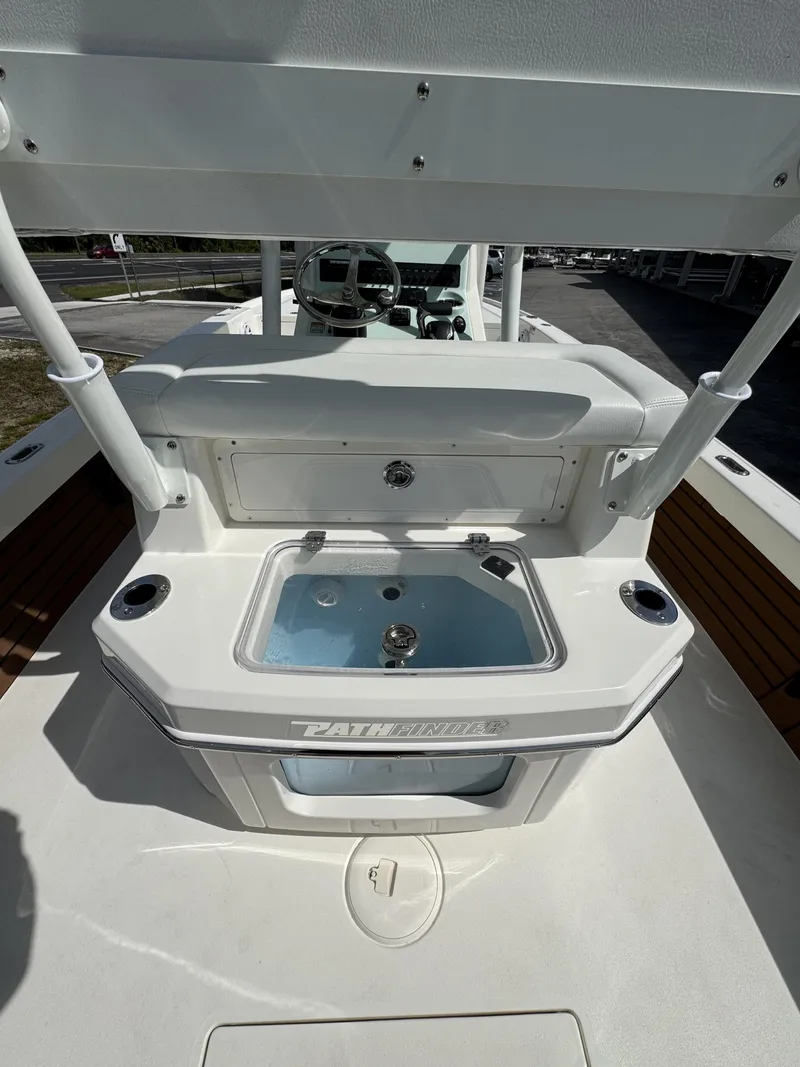 Slide: The Image of Pathfinder 2500 Hybrid 2026 boat console with steering and storage. - 43